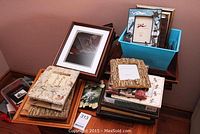 Overall view of multiple picture frames stacked and arranged on table