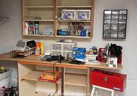 Wide view showing countertop with various tools, cords, step stool, carbon monoxide alarm, toolbox, and small heater.