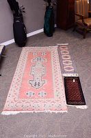 Overview of three rugs on the floor showing colors, patterns, and relative sizes
