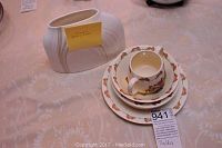 Photo showing the white textured Cypress vase with ribbed design and the stacked Bunnykins set: plate, two bowls, and cup with handles.