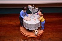 Front view of Royal Doulton porcelain figurine 'Miracle of Light' showing three children around table with menorah and dog underneath.