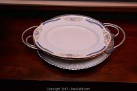 Two Imperial porcelain serving plates on a metal tray, showing patterns and details on edges.