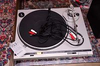 Full view of Technics SL-D20 turntable showing platter, tonearm with attached RCA cables and overall unit