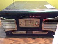 Front view of the vintage style Teac stereo system showing the black casing, chrome speaker grills, and front control panel with tuning dial and CD tray.
