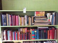 Two shelves with books of various genres and sizes, including music references, fiction, and dictionaries.