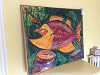 Full view of the painting showing abstract fish design with vibrant colors and textured brushstrokes.