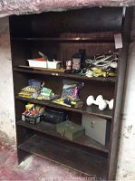 Wooden shelf with various tools, cords, and hardware