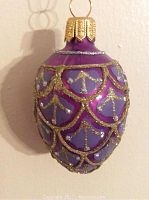 Close-up front view of the purple and gold egg ornament showing detailed hand painted gold glitter patterns.