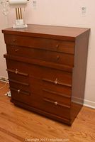 Front view of the vintage chest on chest showing the full height and drawer layout, with a polished dark wood finish and brass handles on lower drawers.