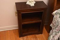 Full front view of the wooden side table showing the open shelf and drawer.