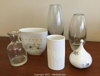 Six pieces: 5 vases varying in glass and porcelain materials plus one porcelain covered dish with floral pattern.