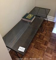 Photo of both wrought iron tables with glass tops in corner, rectangular coffee table and square side table visible with clay tiles on top.