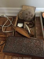 Overview of carved wooden boxes, stoneware plaques and tile, wooden dish, brass bowl and figurine