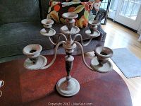 Front view of five-arm candelabra showing overall form and tarnish