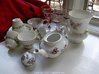 Royal Albert teapot, Regency cups and saucers, wine glasses, sugar pot, and floral vase displayed together