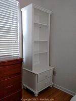 Full view of white wooden hutch showing overall shape and adjustable shelves.