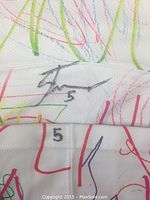 Close-up showing Shawn Tessier's autograph with his number 5 on the white hockey sock, which has colorful abstract designs.