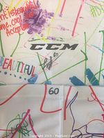 Close up of white CCM logo area with #60 jersey number and autograph in black ink.
