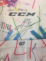 Close-up of sock with CCM logo, number 67, and player autograph #67 Lawson Crouse
