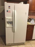 Full front view of the Kenmore two door refrigerator and freezer in white, showing handles and door layout.