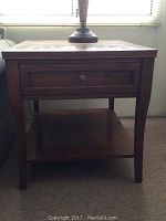 Front view of the dark wood mission style side table showing single drawer and lower shelf.