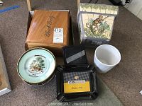 Overview of all items including wooden humidor box, two cocktail plates, two black Cohiba ashtrays, white planter, and monkey-themed planter
