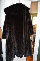 Full front view of dark brown mink fur coat showing shawl collar and belt.