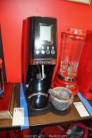 Sodastream machine, marble mortar and pestle, and Waring Pro Blender on shelf against red wall