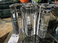 Front/angled view of clear glass vase showing three-lobed wavy form