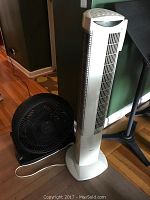 Two fans side by side showing Seville Classics white tower fan and black Honeywell floor fan