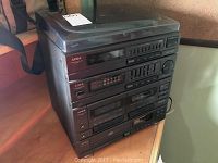 Stacked Aiwa stereo components showing front panels with control buttons and displays