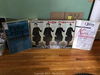 Three framed vintage opera posters displayed side by side on a wooden floor, including two Katya Kabanova posters and one Peter Grimes poster.