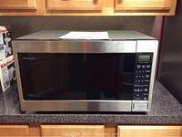 Front view of Panasonic microwave with stainless steel finish and digital control panel on right side.