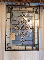 Full front view of the clear and light blue stained glass panel with visible intricate design.