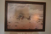 Framed print of wild mustangs by FB Thompson with desert background under cloudy sky.