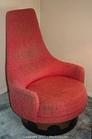 Full three-quarter view of the high-back swivel chair showing overall shape, upholstery color, and wooden base