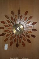 Full frontal view of starburst clock mounted on wall