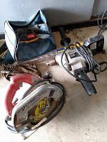 Overall view of the Milwaukee circular saw, Craftsman drill, Ryobi tool bag, and drill bits showing condition and items included.