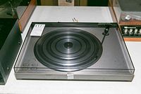 Turntable with dust cover closed showing overall condition and size.