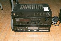 Photo of stacked Rotel RA8208 amplifier, Denon DRA25 receiver, and Fisher CA271 amplifier with graphic equalizer, showing front panels.