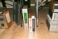 Two vintage audio devices including Pioneer SR-9 and Sansui RA-700 reverberation amplifiers placed on floor.