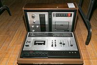 View of the Dual C939 cassette deck and Panasonic RE 7060 stereo cassette deck housed in a wooden casing, showing front panels and controls.