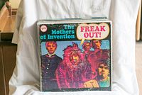 Front cover vinyl record album The Mothers of Invention - Freak Out! with vibrant artwork featuring band members.