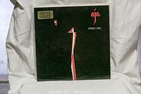 Steely Dan Aja vinyl record cover, black with minimalist artwork and title.