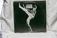 The Man Who Sold The World album cover with David Bowie performing a high kick, black and white image.