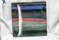 Photo of Wings Over America vinyl record cover displaying airplane fuselage design with title at top