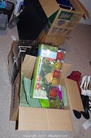 Open box showing multiple sets of string lights in packaging along with floral materials and decorative stems.