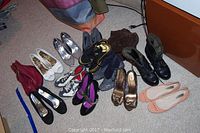 Photo showing the full lot of 14 assorted women's shoes including boots, flats, heels of various styles and colors.
