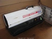 Side view of Reddy heater showing white upper casing with label and black base with handle.