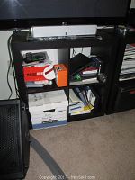 Black 4 cube IKEA storage unit with various items inside and on top used for demonstration, actual contents not included.